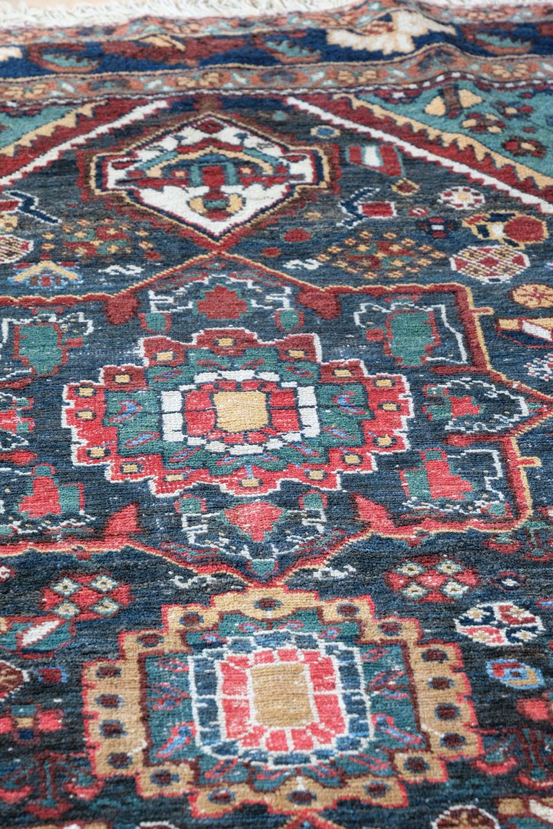 Early 20th century Persian Qashqai wool rug with indigo field, three medallions and blue-green corners, 244 × 159 cm