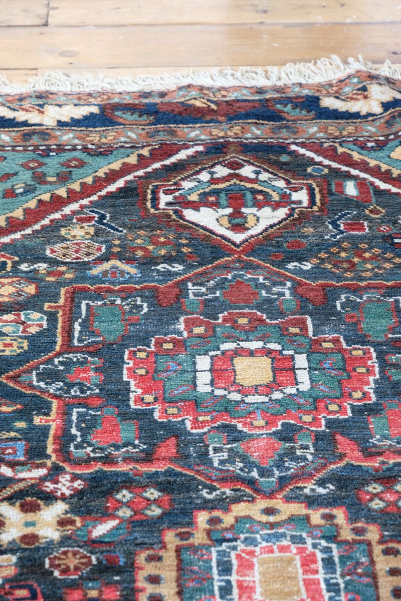 Early 20th century Persian Qashqai wool rug with indigo field, three medallions and blue-green corners, 244 × 159 cm