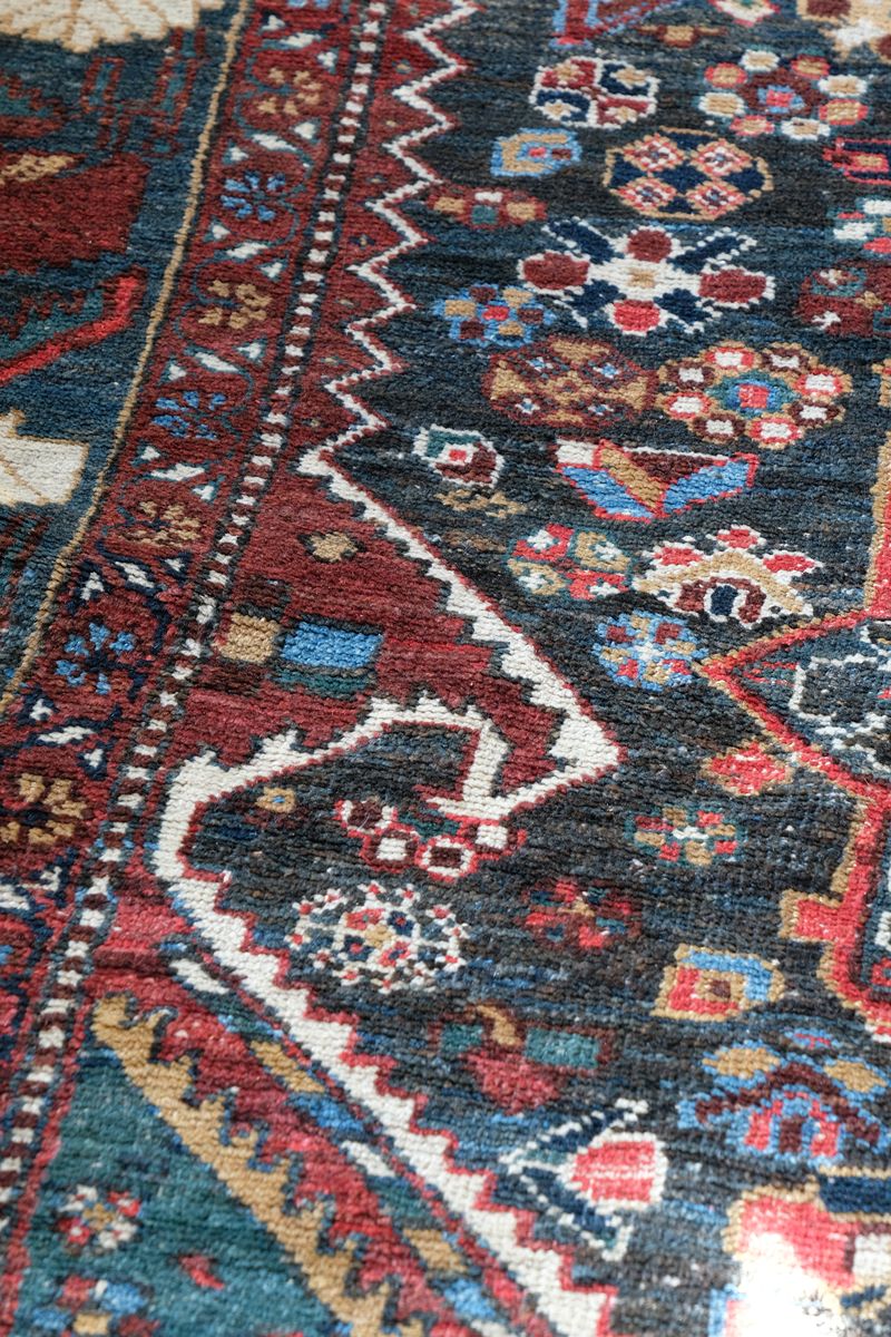 Early 20th century Persian Qashqai wool rug with indigo field, three medallions and blue-green corners, 244 × 159 cm