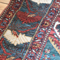 Early 20th century Persian Qashqai wool rug with indigo field, three medallions and blue-green corners, 244 × 159 cm