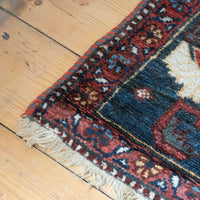 Early 20th century Persian Qashqai wool rug with indigo field, three medallions and blue-green corners, 244 × 159 cm
