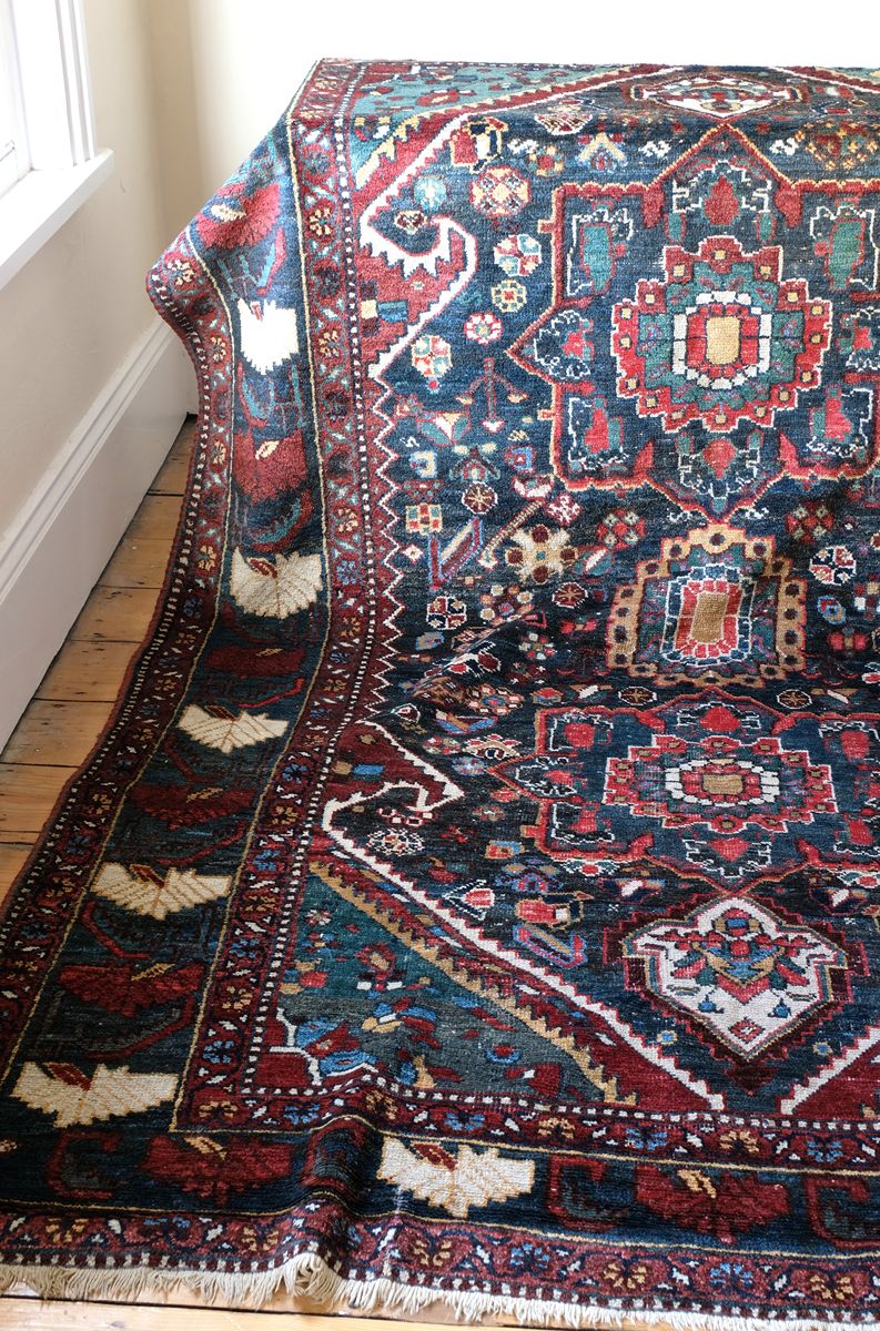 Early 20th century Persian Qashqai wool rug with indigo field, three medallions and blue-green corners, 244 × 159 cm