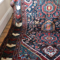 Early 20th century Persian Qashqai wool rug with indigo field, three medallions and blue-green corners, 244 × 159 cm