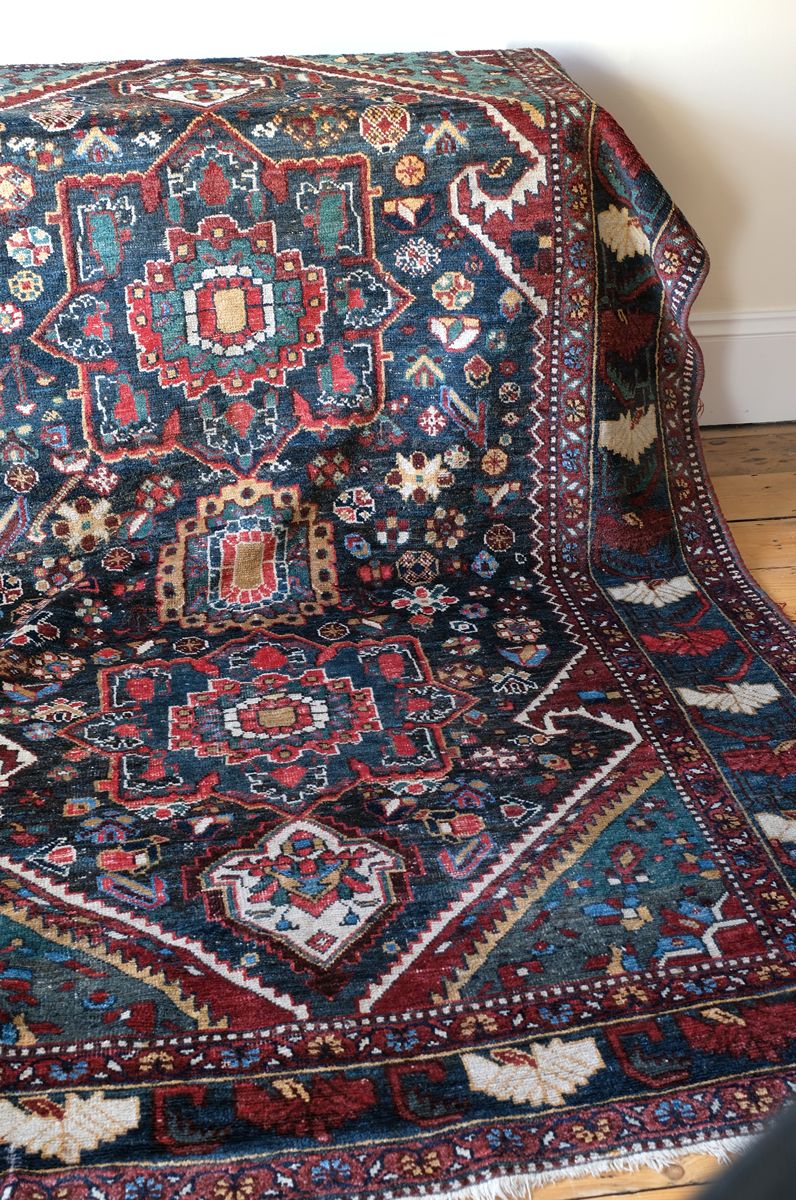 Early 20th century Persian Qashqai wool rug with indigo field, three medallions and blue-green corners, 244 × 159 cm