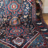 Early 20th century Persian Qashqai wool rug with indigo field, three medallions and blue-green corners, 244 × 159 cm