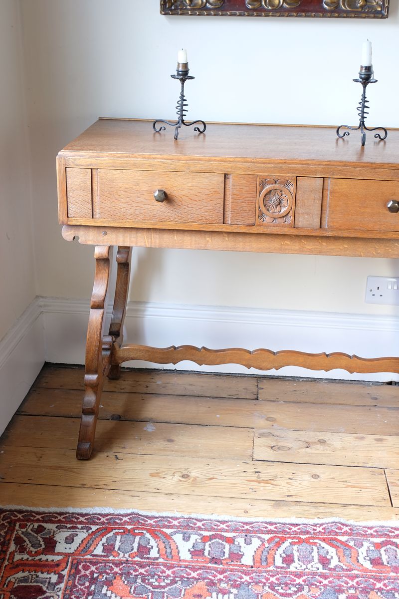 Side shot on the Arts & Crafts oak console table by Beresford & Hicks with two drawers and shaped trestle supports