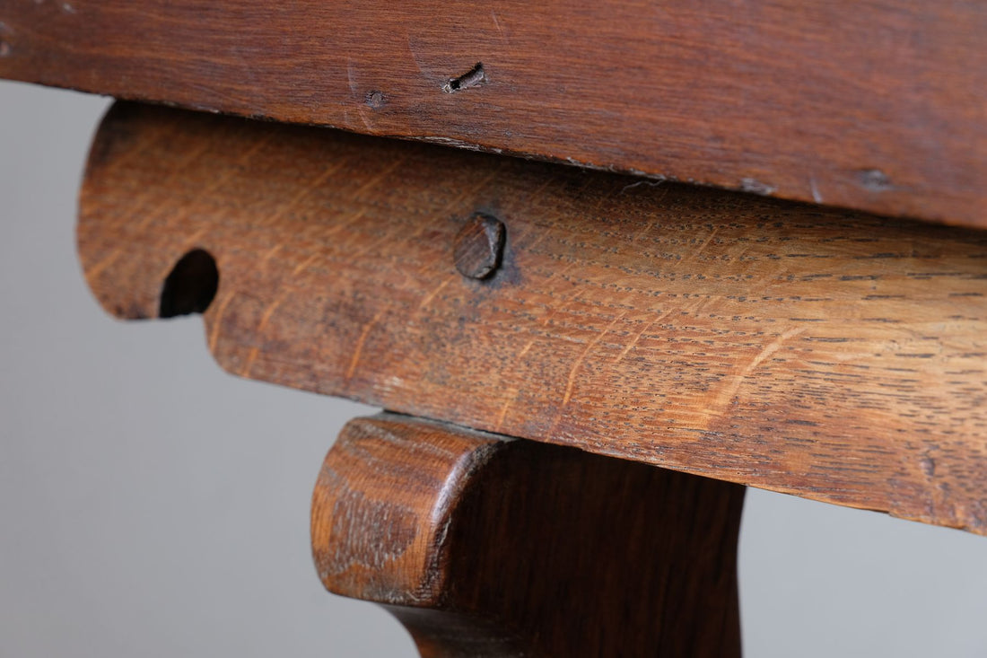 Scroll end supports and peg jointed construction on the Arts & Crafts oak console table by Beresford & Hicks with two drawers and shaped trestle supports