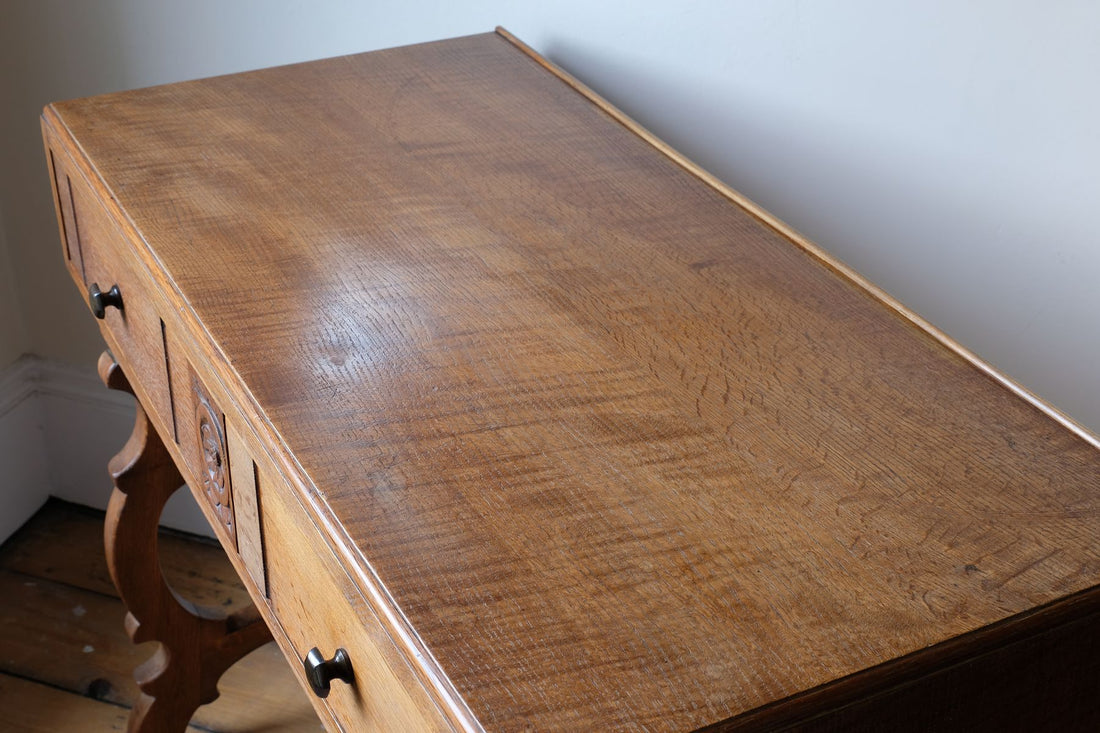 Medullary rays throughout the oak top and side on the Arts & Crafts oak console table by Beresford & Hicks with two drawers and shaped trestle supports