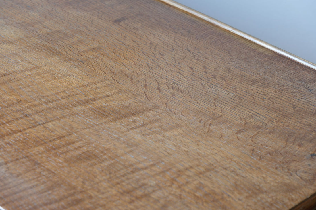 Medullary rays throughout the oak top and side on the Arts & Crafts oak console table by Beresford & Hicks with two drawers and shaped trestle supports
