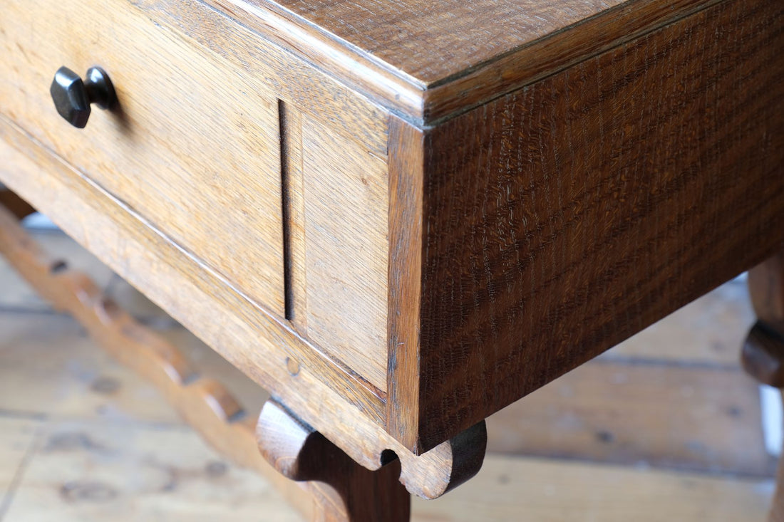 Profiled corner detail on the Arts & Crafts oak console table by Beresford & Hicks with two drawers and shaped trestle supports