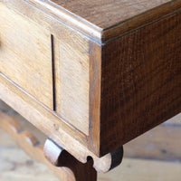 Profiled corner detail on the Arts & Crafts oak console table by Beresford & Hicks with two drawers and shaped trestle supports