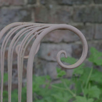 Painted wrought iron garden bench with Gothic arch back, scroll armrests and slatted seat