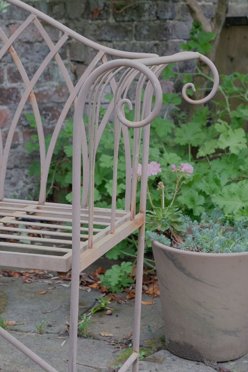 close up of the scroll arms on the Painted wrought iron garden bench with Gothic arch back, scroll armrests and slatted seat 
