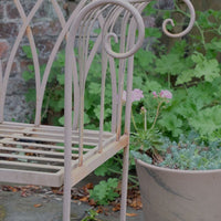 close up of the scroll arms on the Painted wrought iron garden bench with Gothic arch back, scroll armrests and slatted seat 