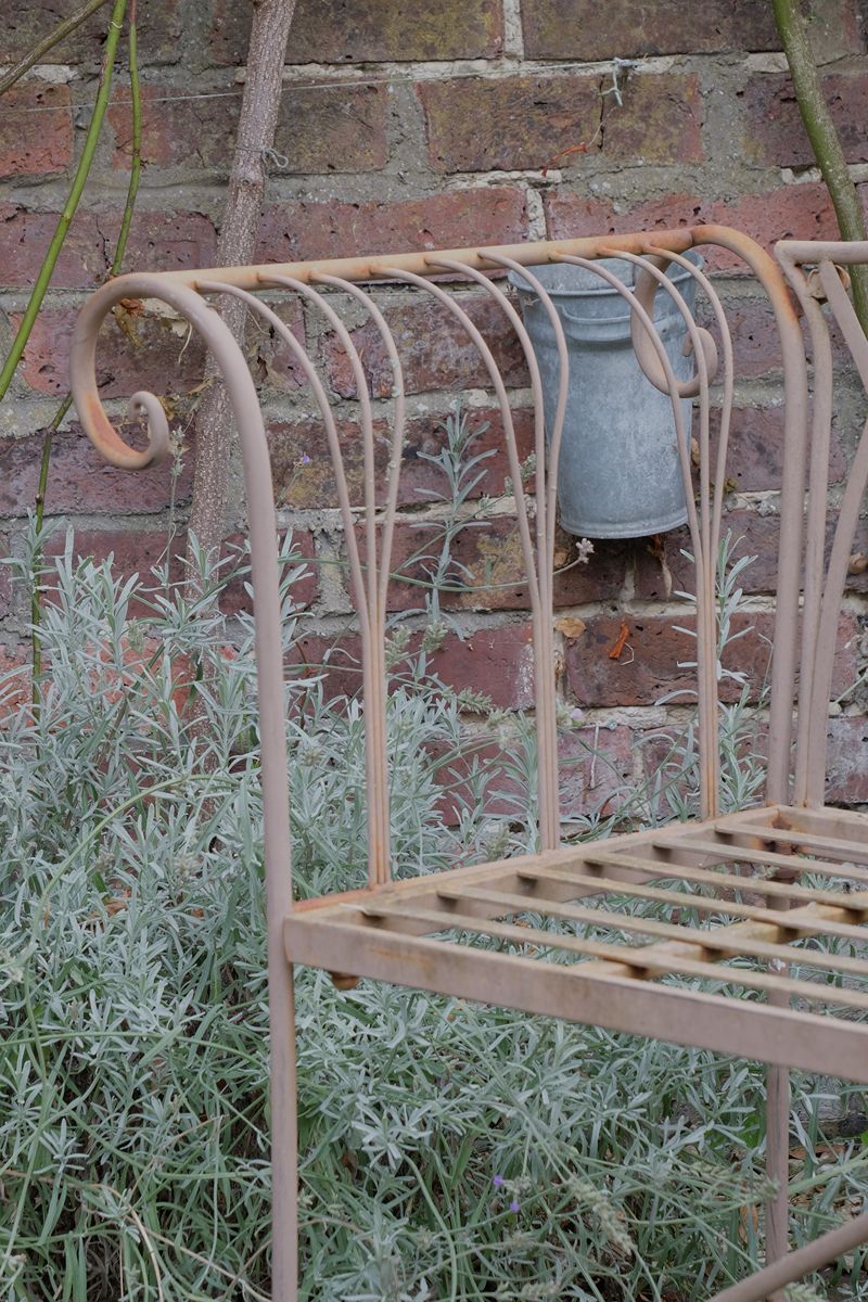 close up of the fork arm design on the Painted wrought iron garden bench with Gothic arch back, scroll armrests and slatted seat
