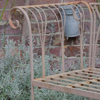 close up of the fork arm design on the Painted wrought iron garden bench with Gothic arch back, scroll armrests and slatted seat