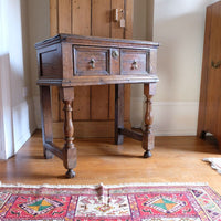 18th century country oak side table with a single panelled drawer, brass handles and baluster-turned front legs