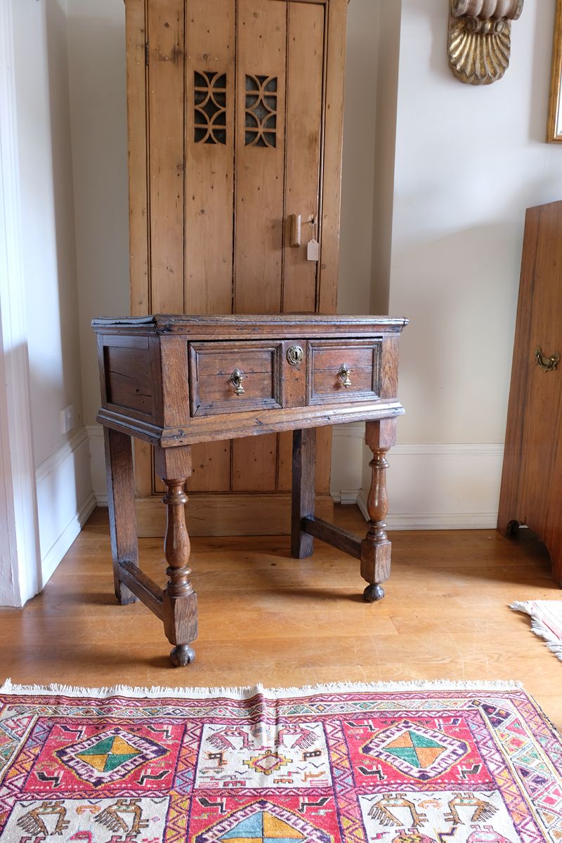 18th century country oak side table with a single panelled drawer, brass handles and baluster-turned front legs
