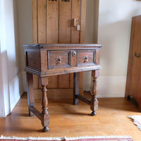18th century country oak side table with a single panelled drawer, brass handles and baluster-turned front legs