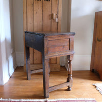 Side panel view - 18th century country oak side table with a single panelled drawer, brass handles and baluster-turned front legs