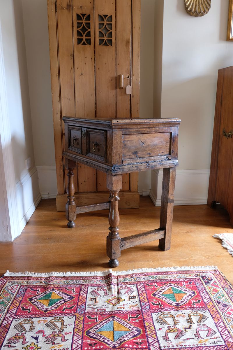 18th century country oak side table with a single panelled drawer, brass handles and baluster-turned front legs