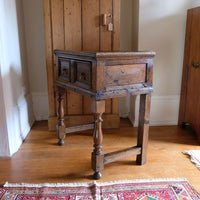 18th century country oak side table with a single panelled drawer, brass handles and baluster-turned front legs