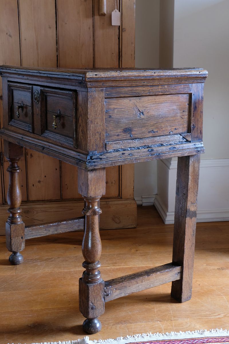 18th century country oak side table with a single panelled drawer, brass handles and baluster-turned front legs