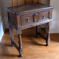 18th century country oak side table with a single panelled drawer, brass handles and baluster-turned front legs