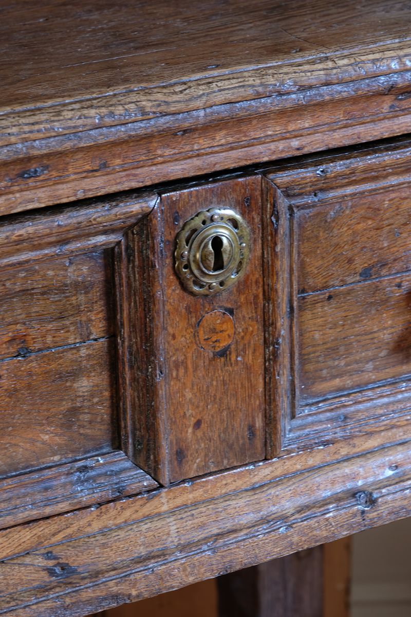 18th century country oak side table with a single panelled drawer, brass handles and baluster-turned front legs