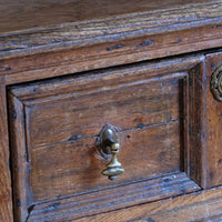 close up of the drawer front - 18th century country oak side table with a single panelled drawer, brass handles and baluster-turned front legs