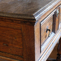 18th century country oak side table with a single panelled drawer, brass handles and baluster-turned front legs