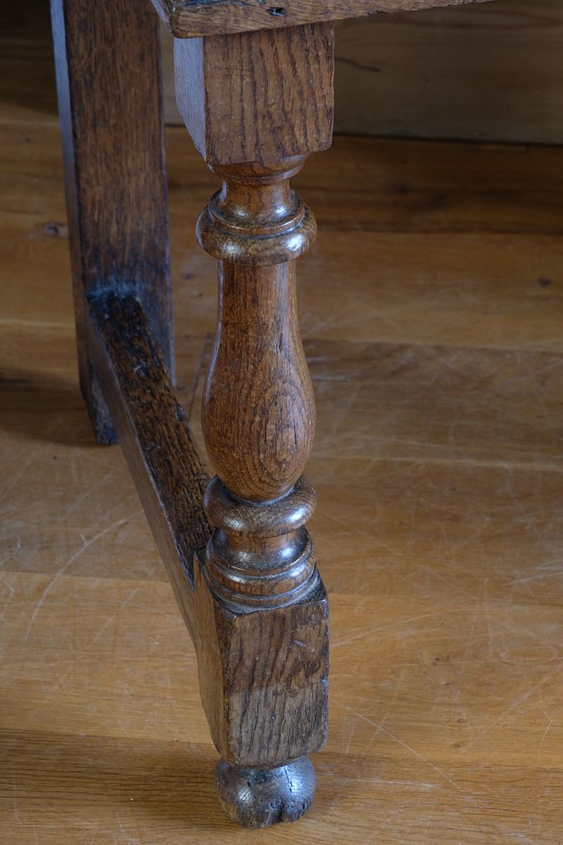 18th century country oak side table with a single panelled drawer, brass handles and baluster-turned front legs