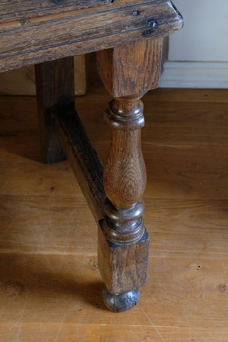 18th century country oak side table with a single panelled drawer, brass handles and baluster-turned front legs