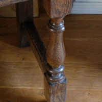 18th century country oak side table with a single panelled drawer, brass handles and baluster-turned front legs